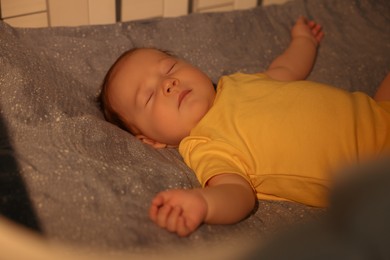 Cute newborn baby sleeping in crib at night