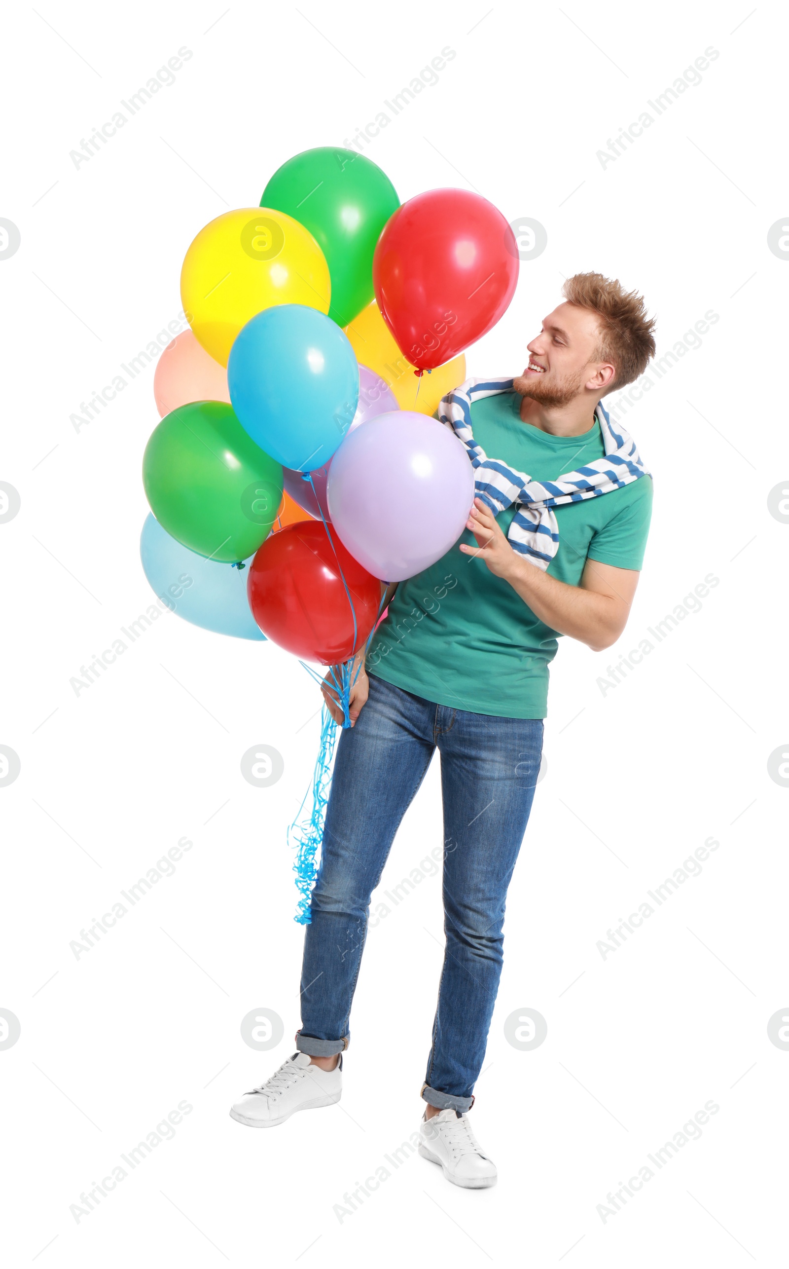 Photo of Young man holding bunch of colorful balloons on white background