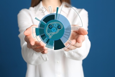 Woman demonstrating digital image of brain on blue background, closeup. Machine learning concept