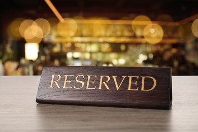 Image of Sign Reserved on wooden table in restaurant