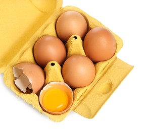 Photo of Chicken eggs in carton isolated on white, top view