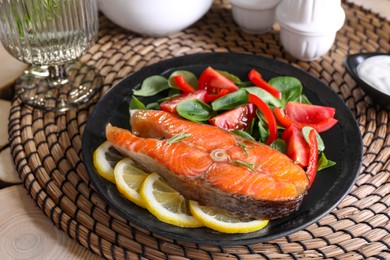 Photo of Healthy meal. Tasty grilled salmon with vegetables and lemon served on wooden table, closeup