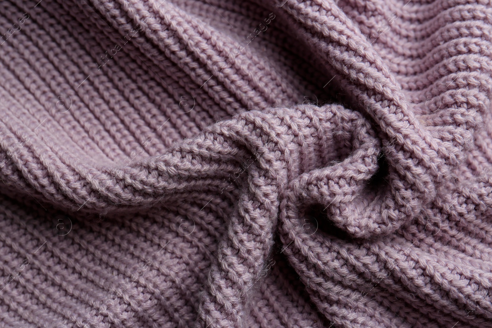 Photo of Beautiful violet knitted fabric as background, top view