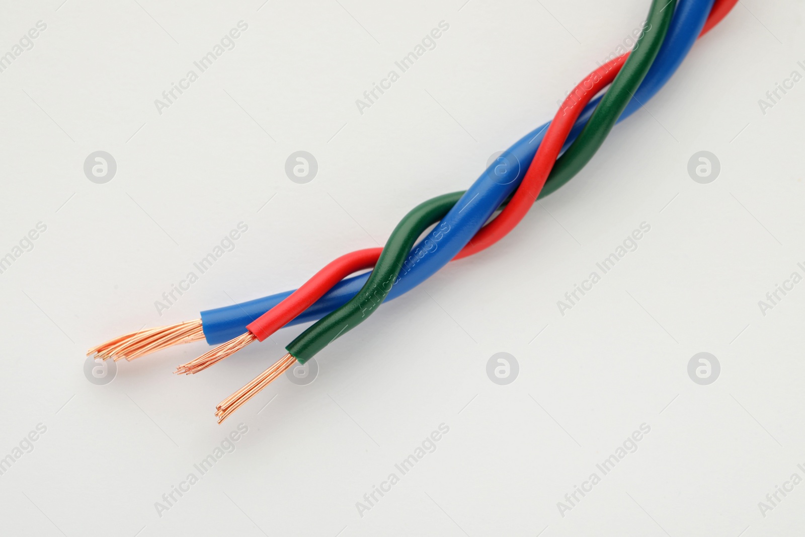 Photo of Colorful electrical wires on white background, closeup