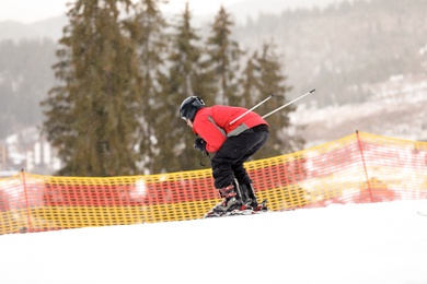 Skier on slope at resort. Winter vacation