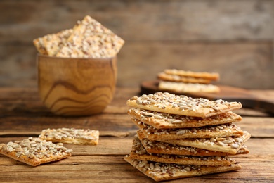Photo of Stack of delicious crackers on wooden table