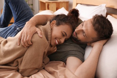 Photo of Lovely couple enjoying each other on bed at home