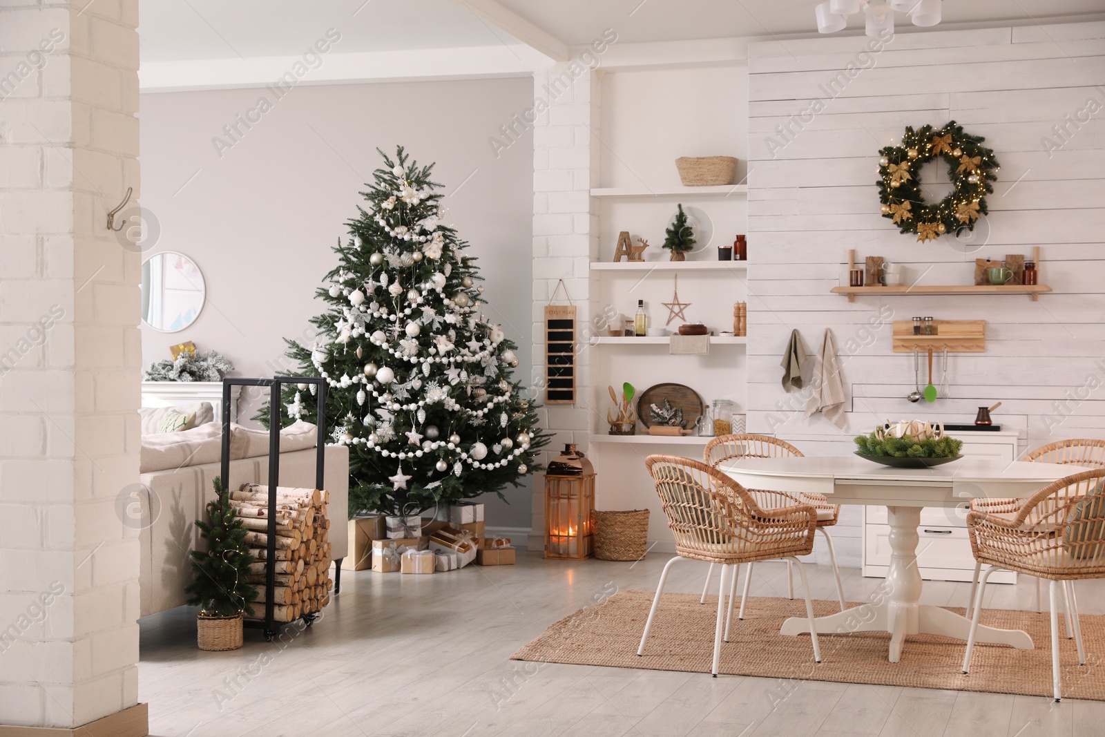 Photo of Cozy dining room interior with Christmas tree and festive decor