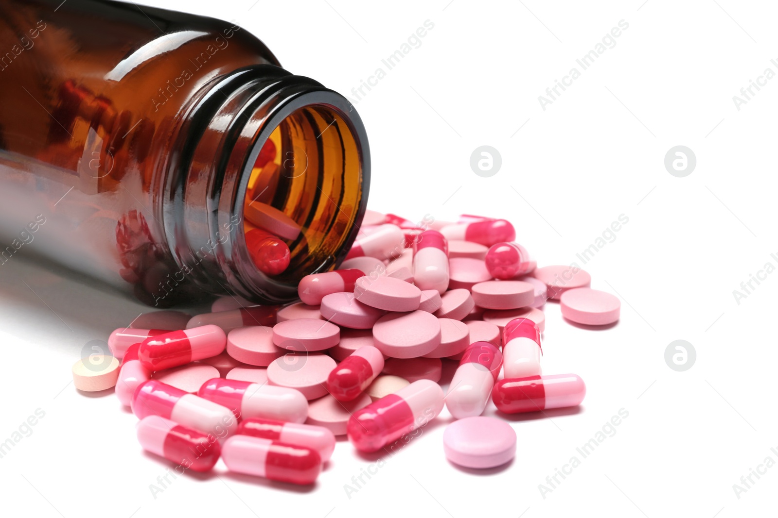 Photo of Bottle with vitamin pills and capsules on white background, closeup