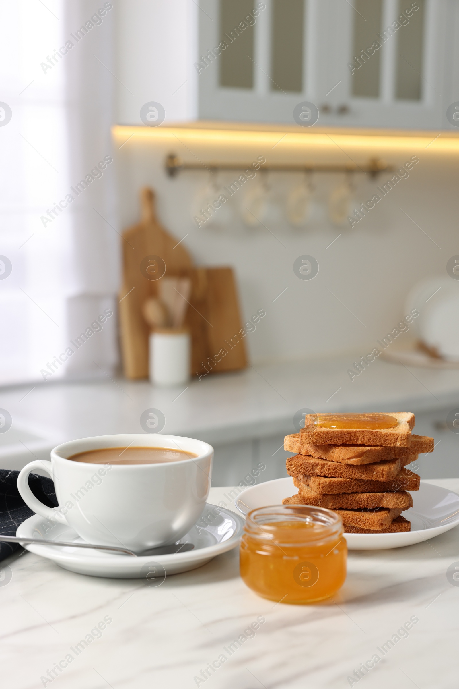Photo of Breakfast served in kitchen. Fresh toasts, coffee and honey on white marble table. Space for text