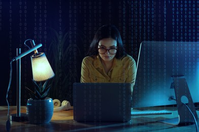 Image of Programmer working in modern office at night