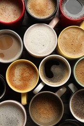 Many different cups with aromatic coffee on table, flat lay