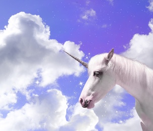 Image of Magic unicorn in fantastic sky with fluffy clouds