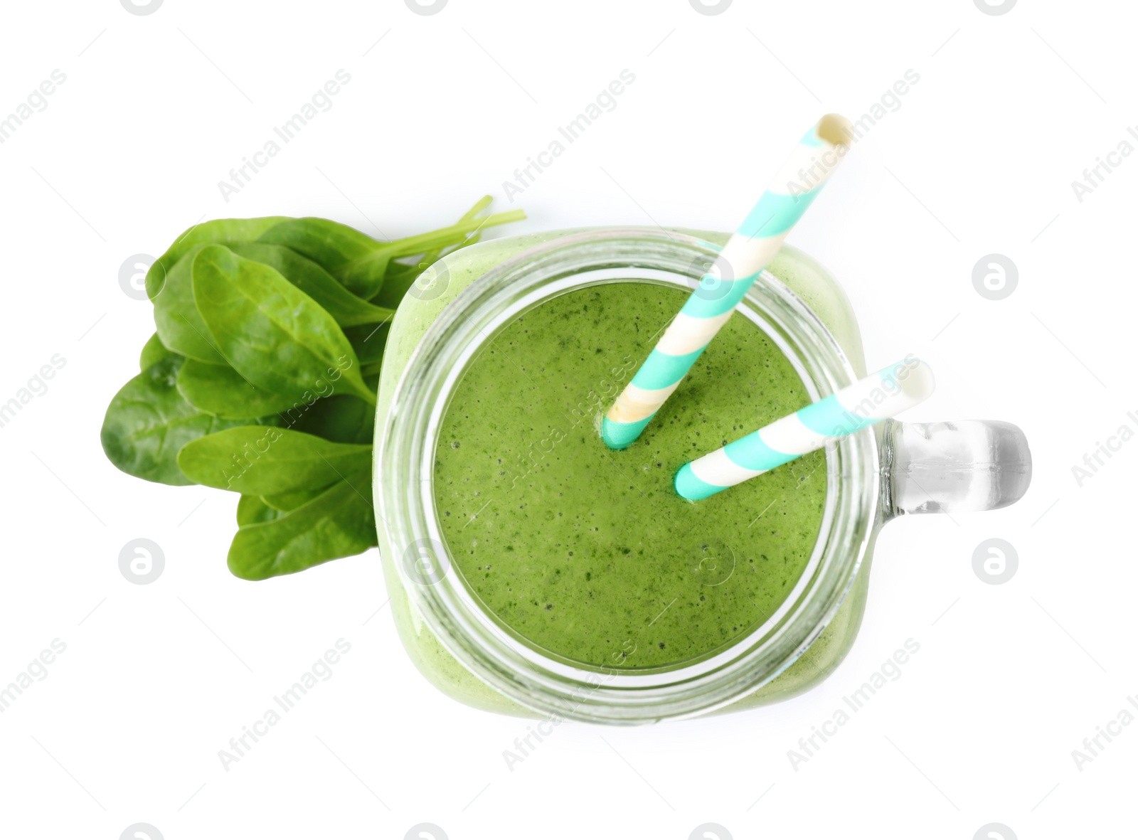 Photo of Mason jar of healthy green smoothie with fresh spinach on white background, top view