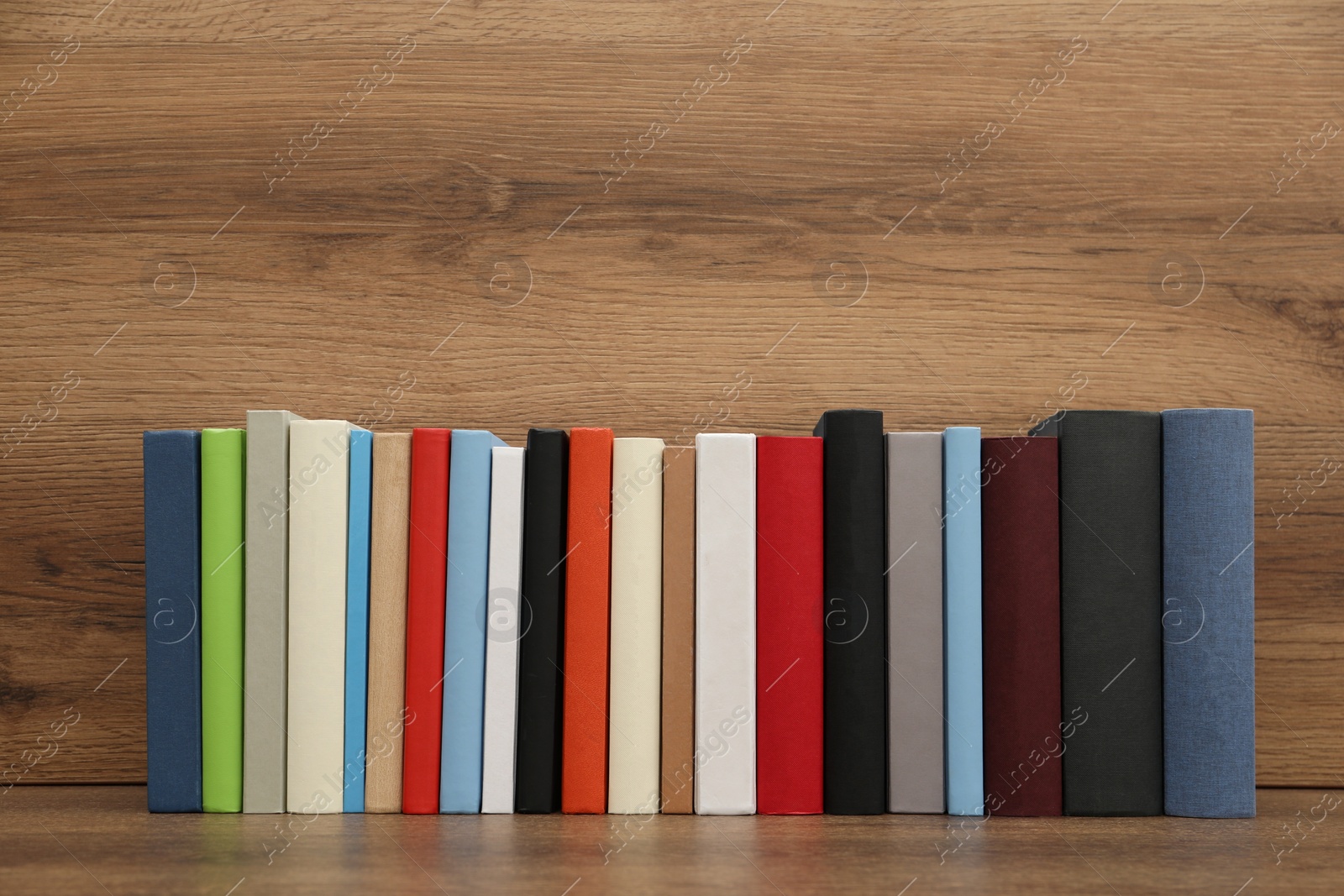 Photo of Many different hardcover books on wooden background