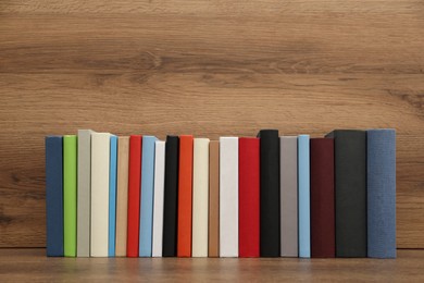 Many different hardcover books on wooden background