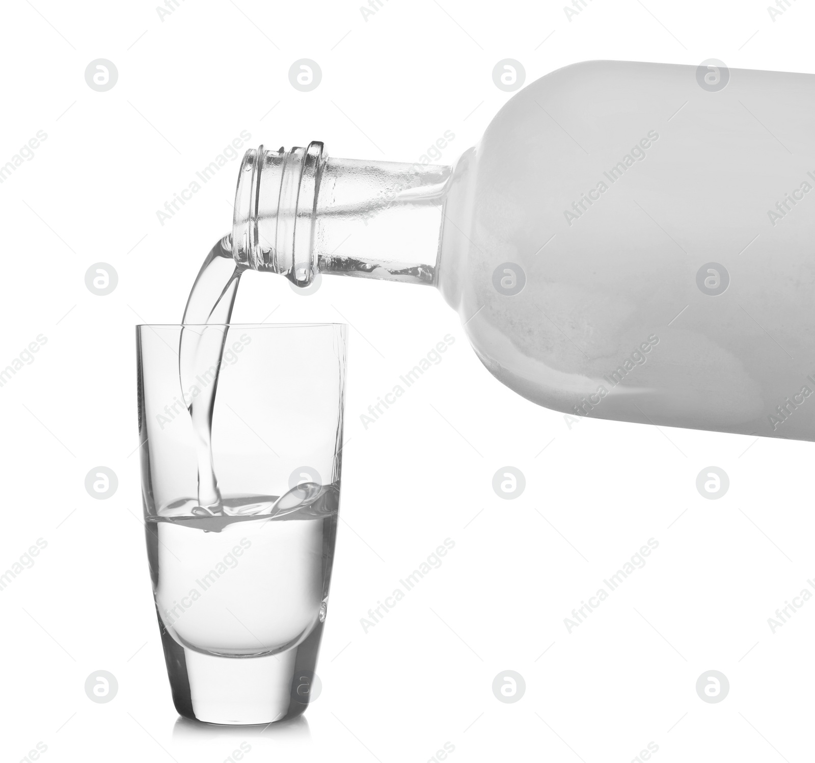 Photo of Pouring cold vodka into shot glass on white background