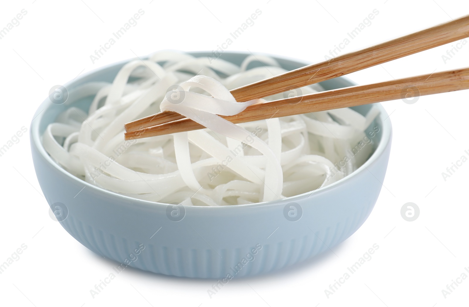 Photo of Chopsticks with tasty cooked rice noodles over bowl isolated on white