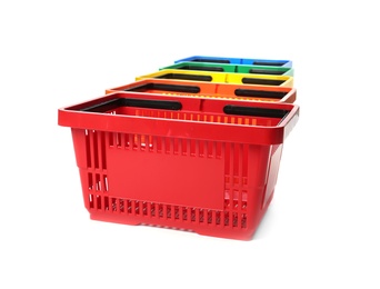 Colorful plastic shopping baskets on white background