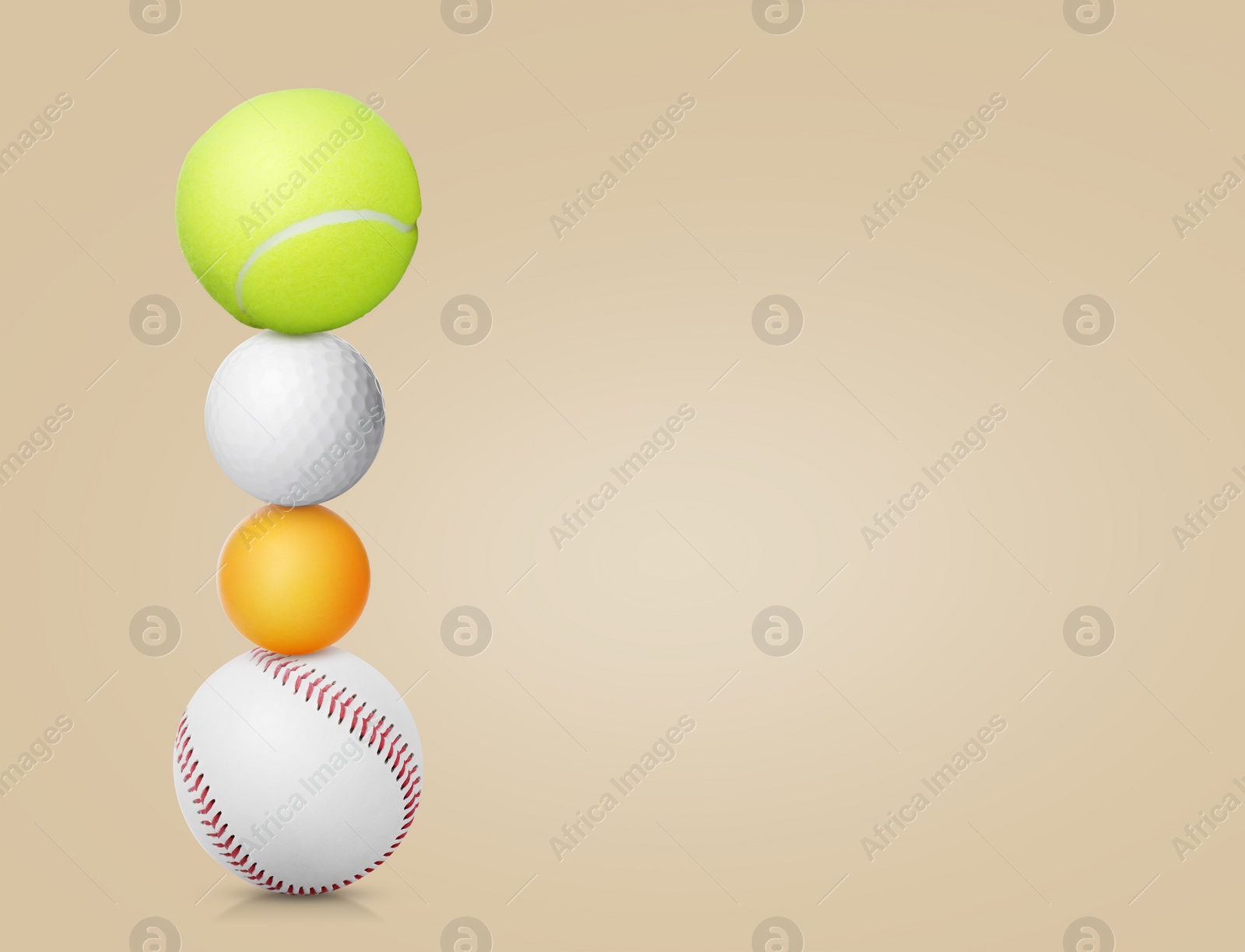 Image of Stack of different sport balls on beige background, space for text