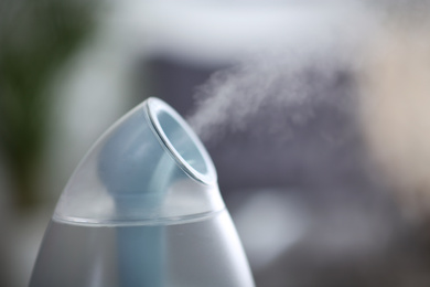 Photo of Modern air humidifier indoors, closeup. Space for text