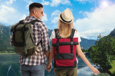 Happy couple with travel backpacks enjoying their summer vacation trip
