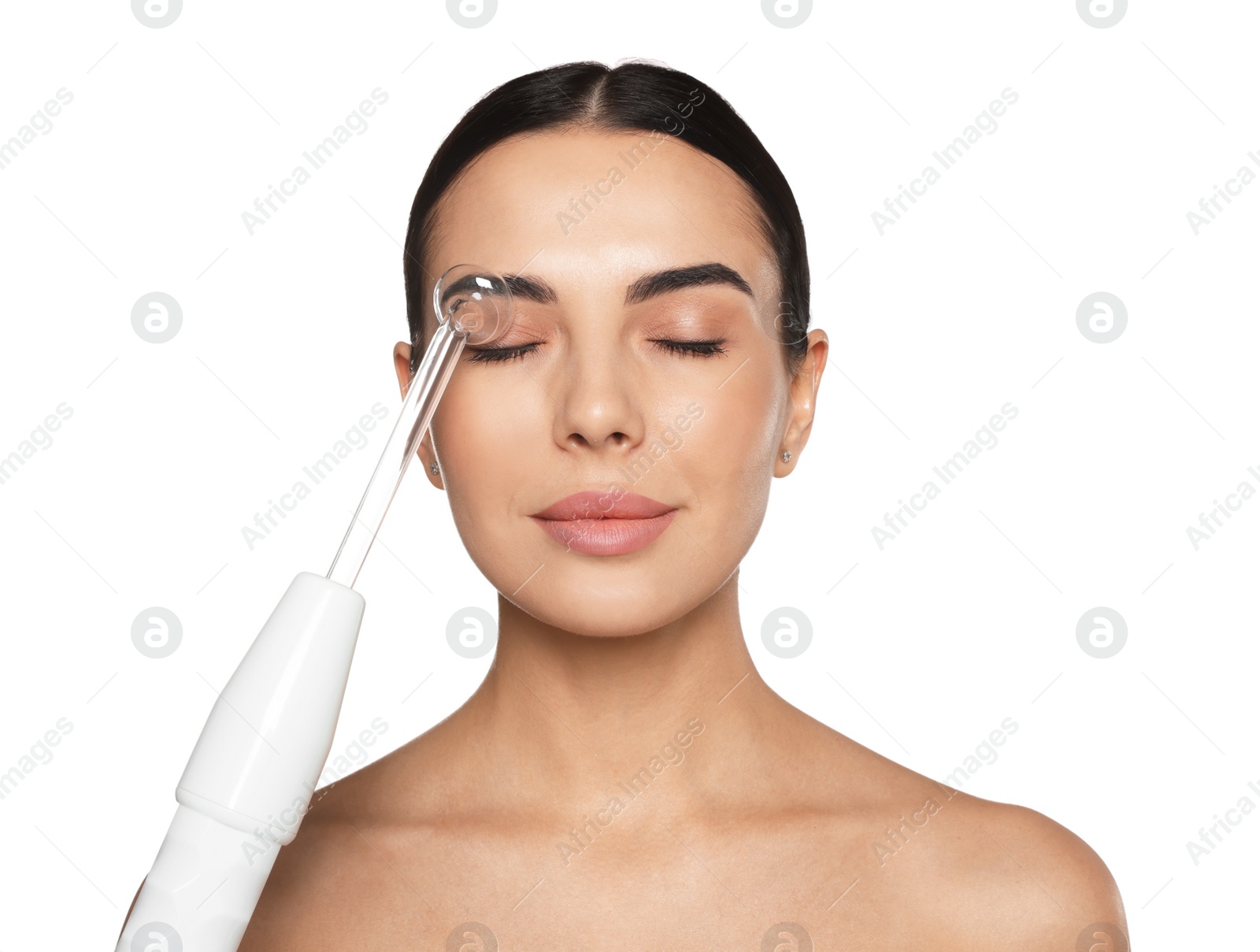 Photo of Woman using high frequency darsonval device on white background