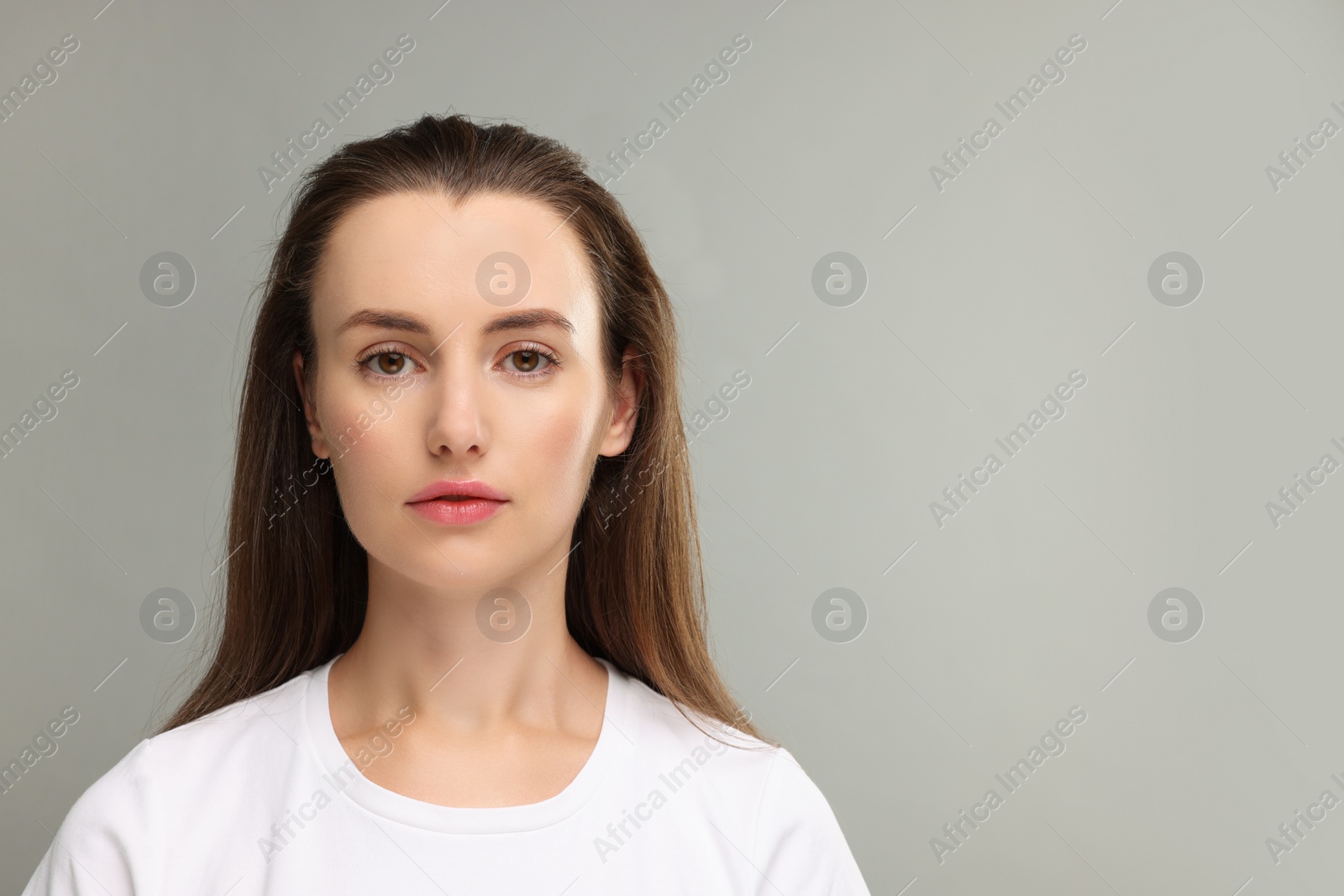 Photo of Portrait of beautiful woman on light gray background. Space for text