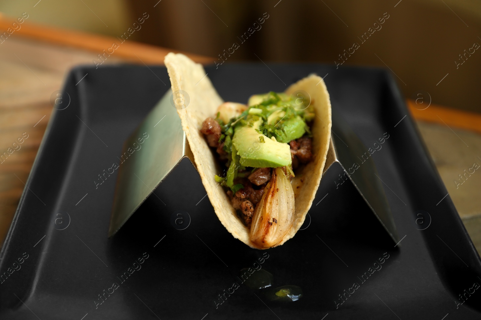Photo of Delicious tacos with fresh ingredients on plate, closeup