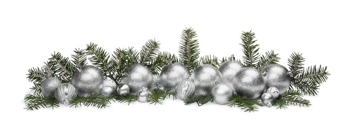 Photo of Many silver Christmas balls and fir twigs isolated on white