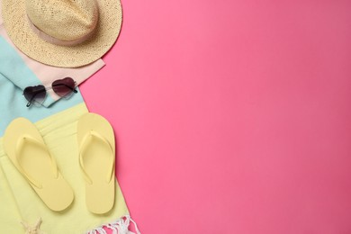 Photo of Flat lay composition with different beach objects on pink background, space for text