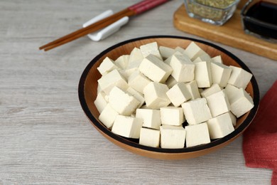 Delicious tofu in bowl on light wooden table