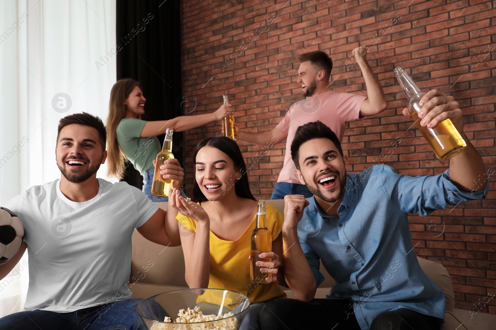 Photo of Group of friends watching football at home