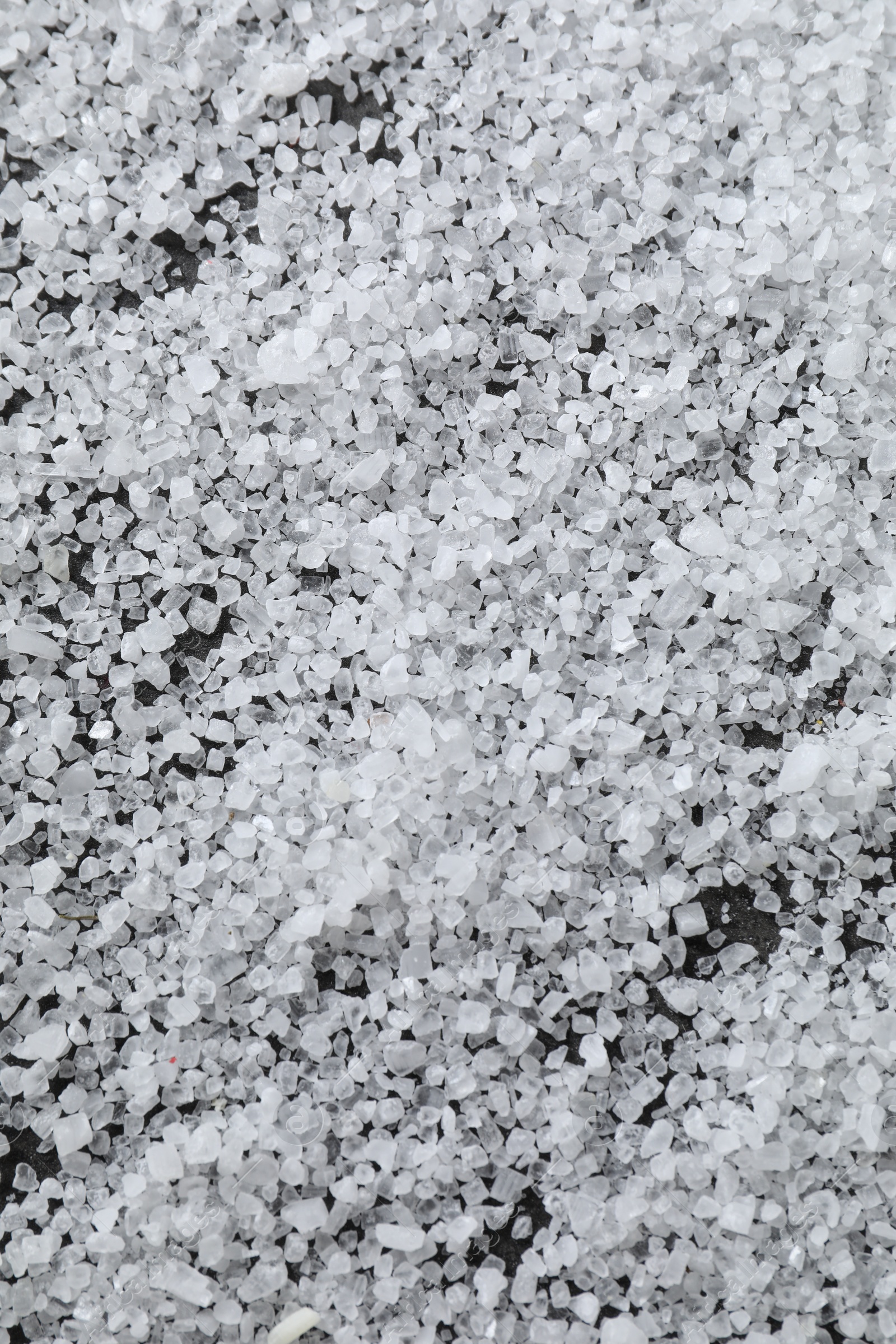 Photo of White natural salt as background, closeup view