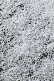 Photo of White natural salt as background, closeup view