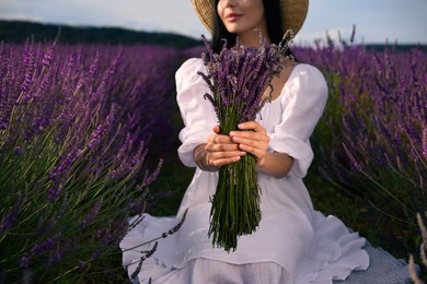 Woman with beautiful bouquet in lavender field, closeup