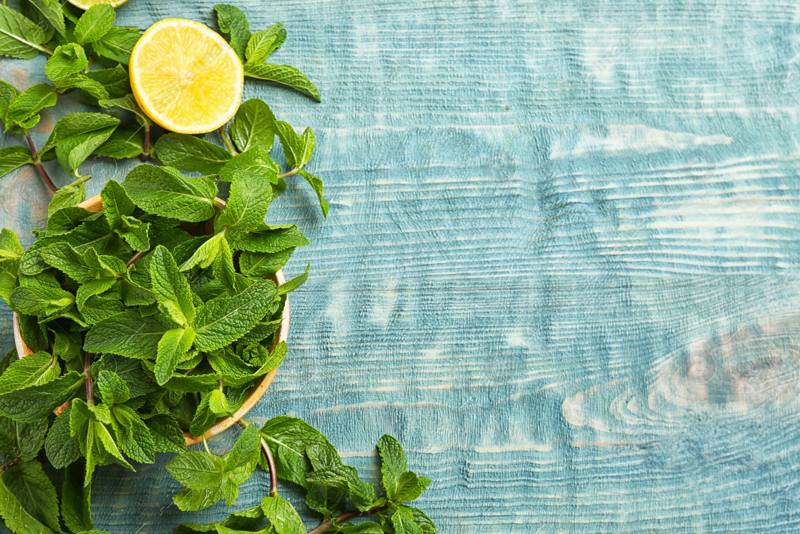 Photo of Flat lay composition with mint and lemon on wooden background