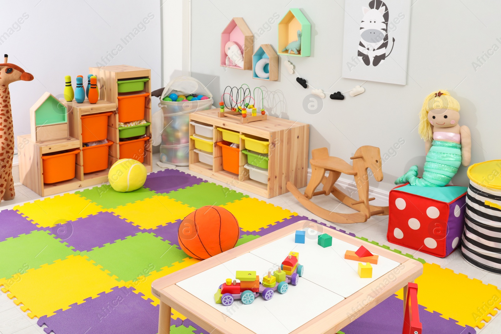 Photo of Cute child's room interior with toys and modern furniture