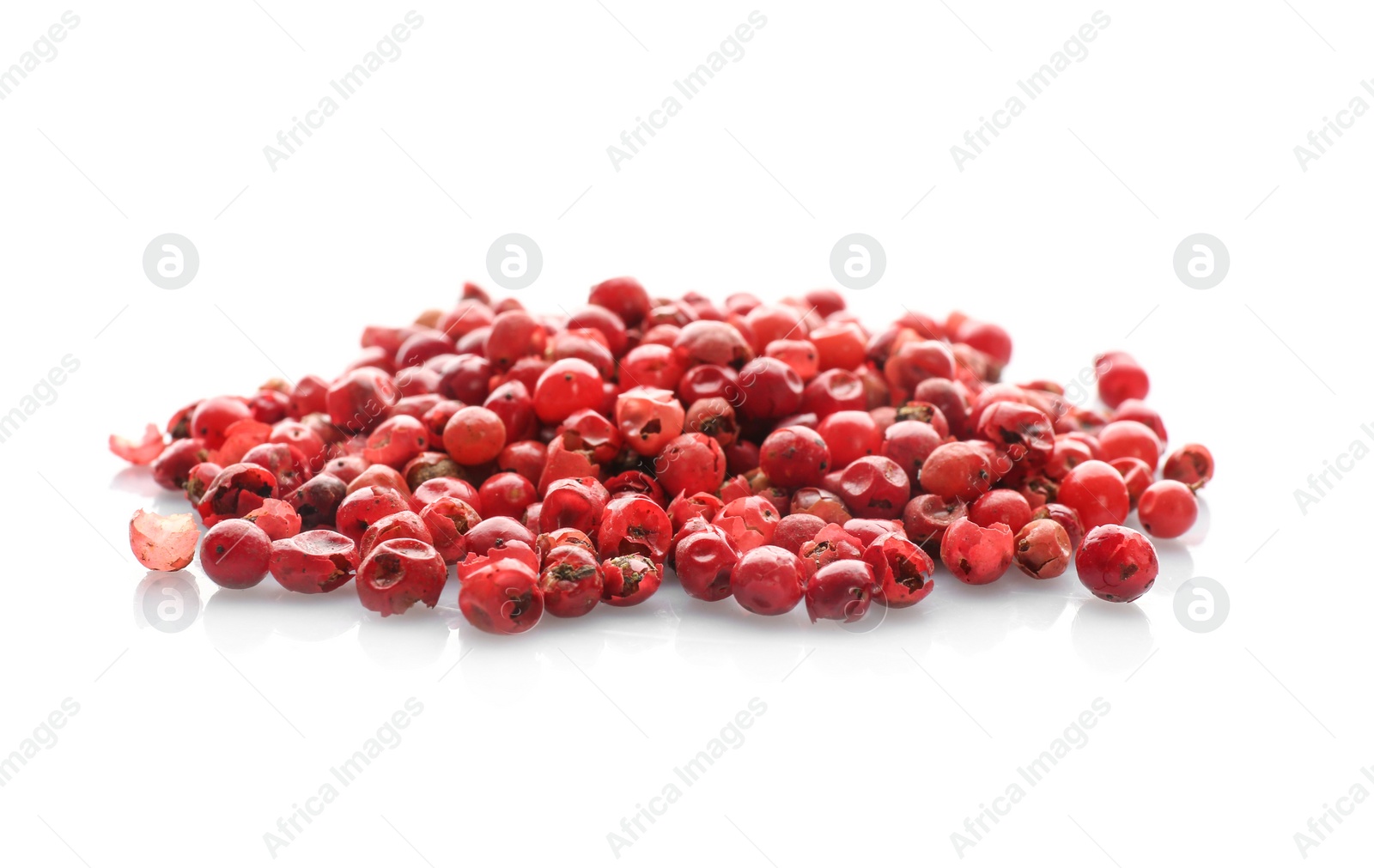 Photo of Heap of red peppercorns on white background