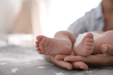 Mother and her little baby on bed, closeup