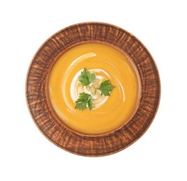 Delicious pumpkin soup with seeds and parsley in bowl isolated on white, top view