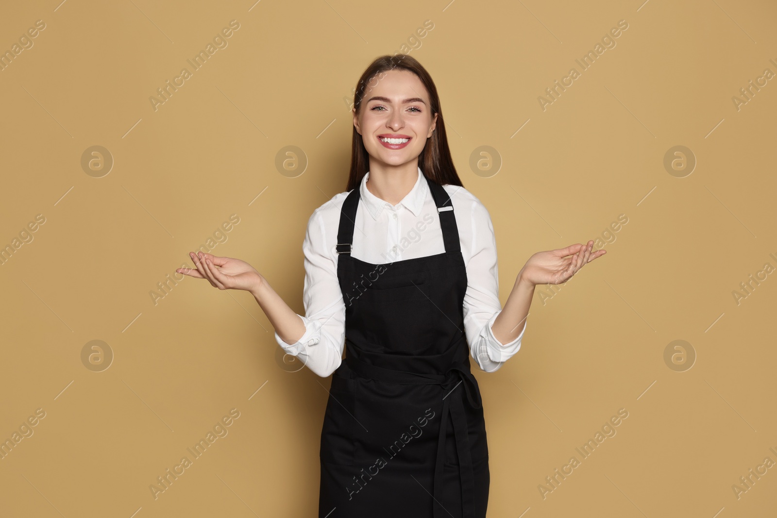Photo of Portrait of happy hairdresser on beige background
