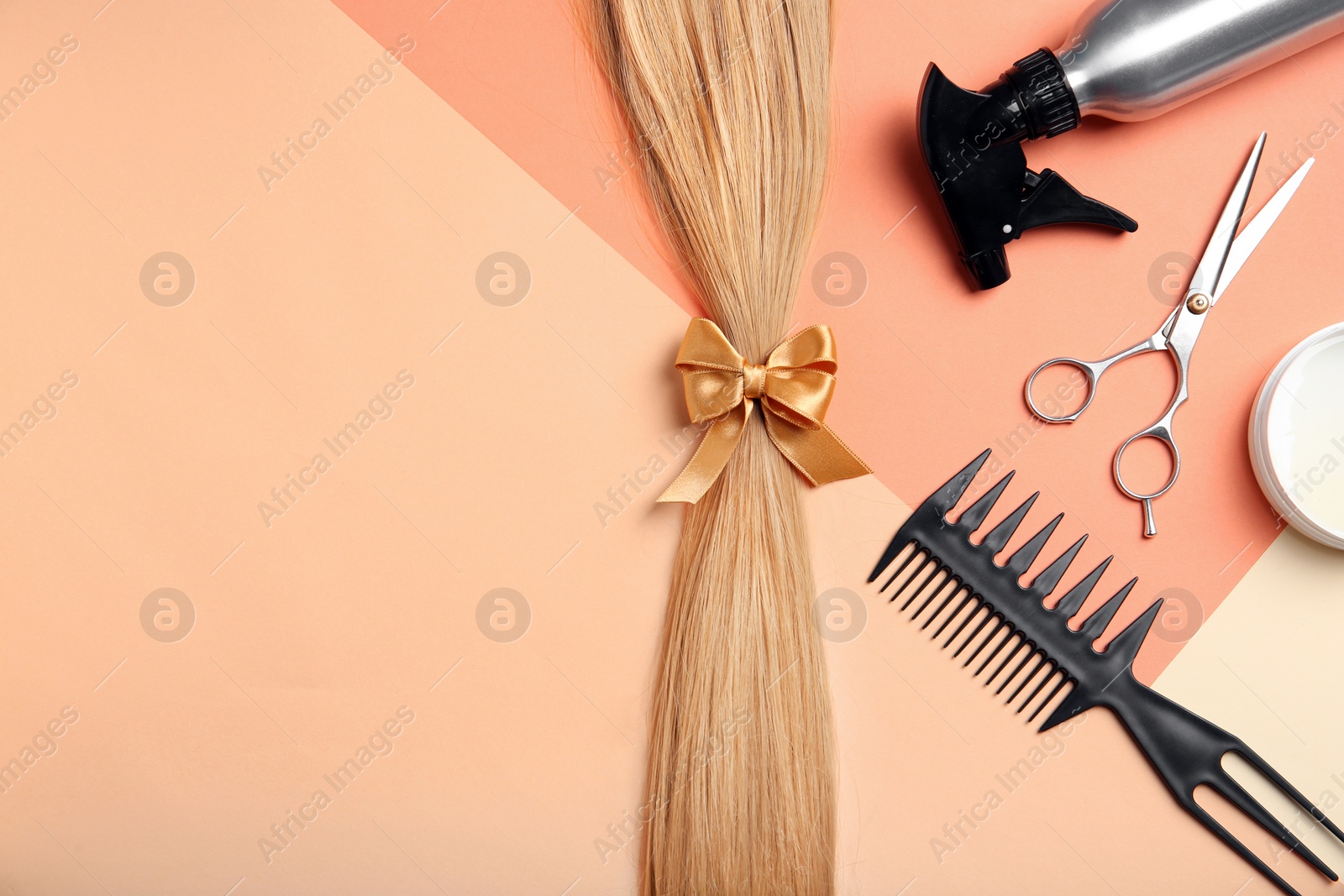 Photo of Flat lay composition with hair salon tools and space for text on color background