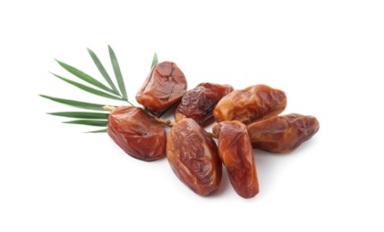 Photo of Sweet dates on branch and green leaves against white background. Dried fruit as healthy snack