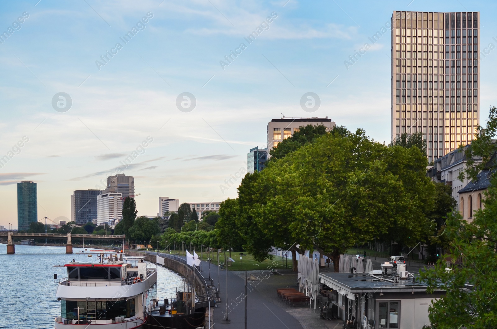 Photo of Beautiful view of cityscape with boat on river and pier