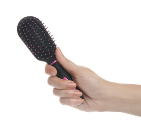 Woman holding modern hair brush on white background, closeup