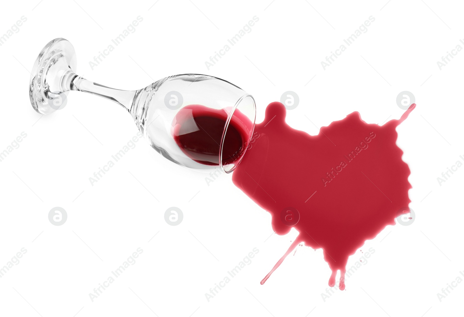 Photo of Overturned glass and spilled wine on white background, top view
