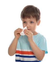 Photo of Sick little boy using nasal spray on white background
