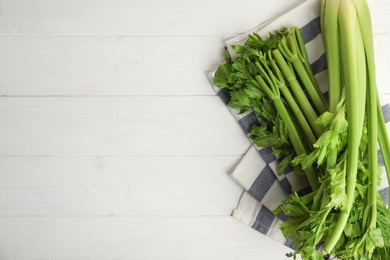 Photo of Fresh ripe green celery on white wooden table, flat lay. Space for text