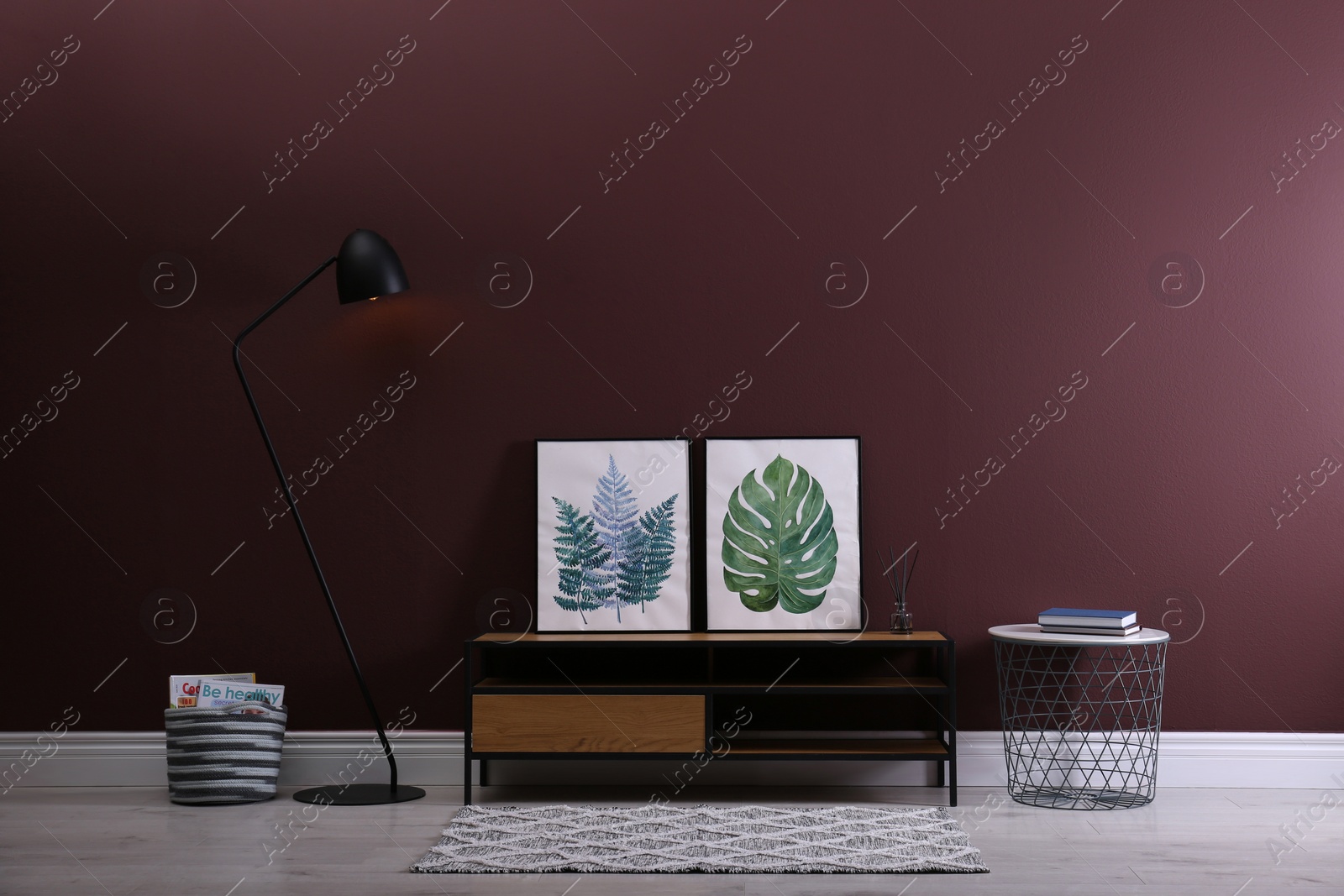 Photo of Elegant room interior with wooden cabinet and floor lamp near brown wall